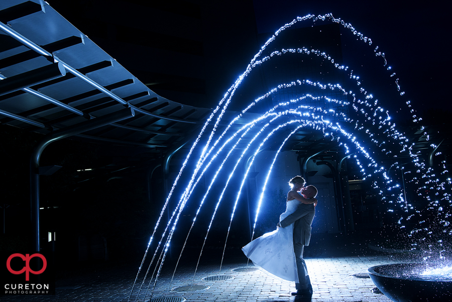 Bride and Groom in the fountains after their Commerce Club Greenville wedding reception.