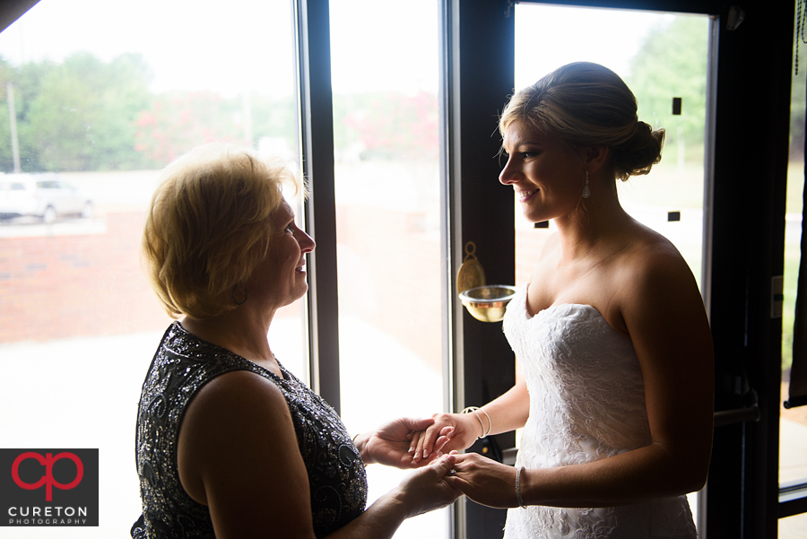 Bride and her mom sharing a moment before the wedding.