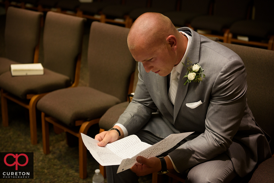 Groom reading a letter from his bride.