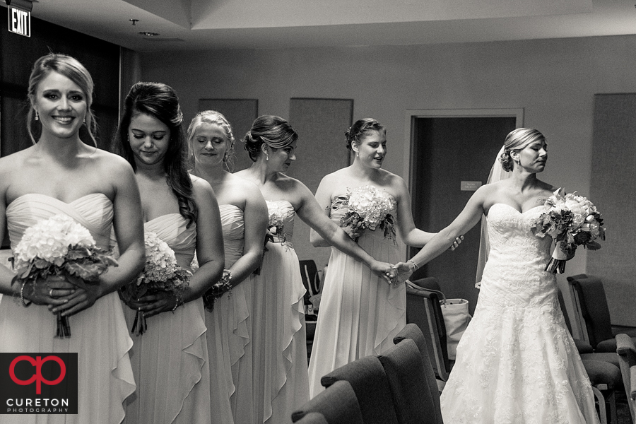Bride and bridesmaids praying before the ceremony.