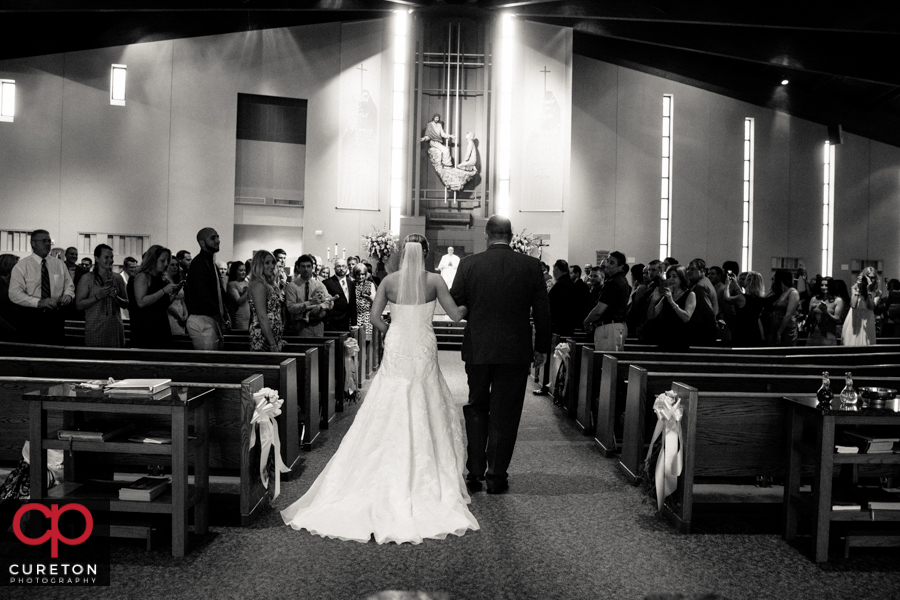 Bride and father walking down the aisle.