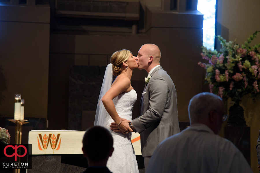 Bride and groom first kiss.