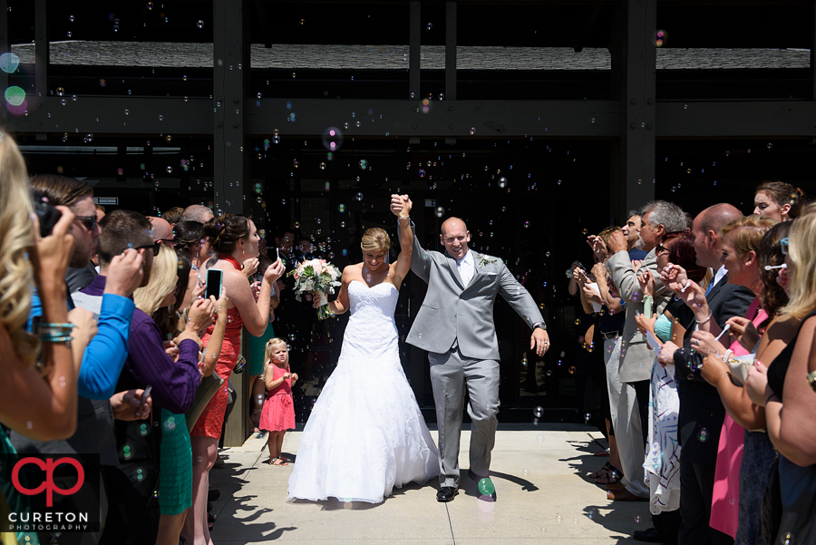 Bride and groom bubble leave at the church.