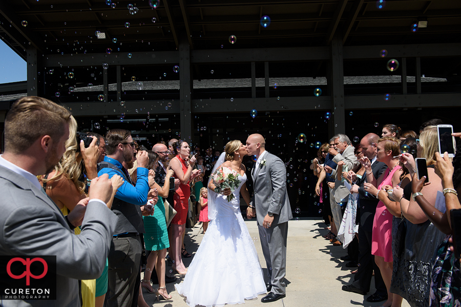 Bride and groom bubble leave at the church.