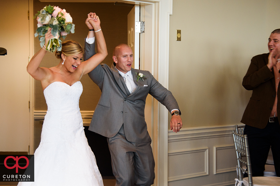 Bride and groom make their grand entrance into the wedding reception at the Commerce Club.