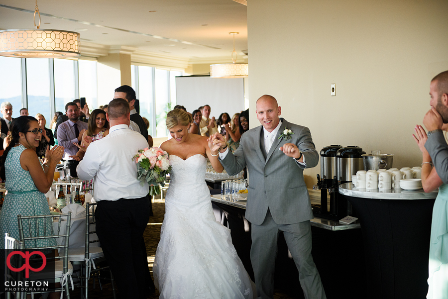 Bride and groom make their grand entrance into the wedding reception at the Commerce Club.