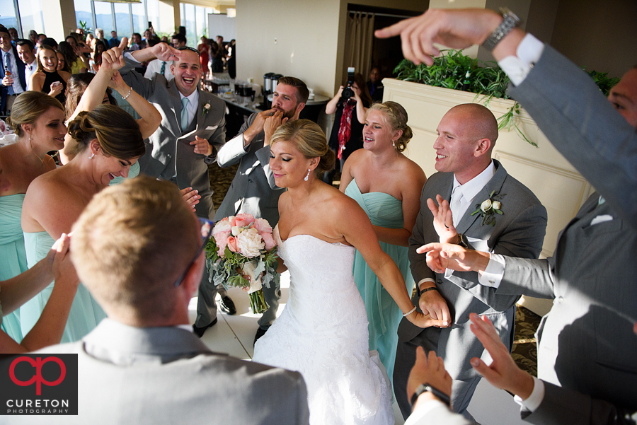 Bride and groom make their grand entrance into the wedding reception at the Commerce Club.