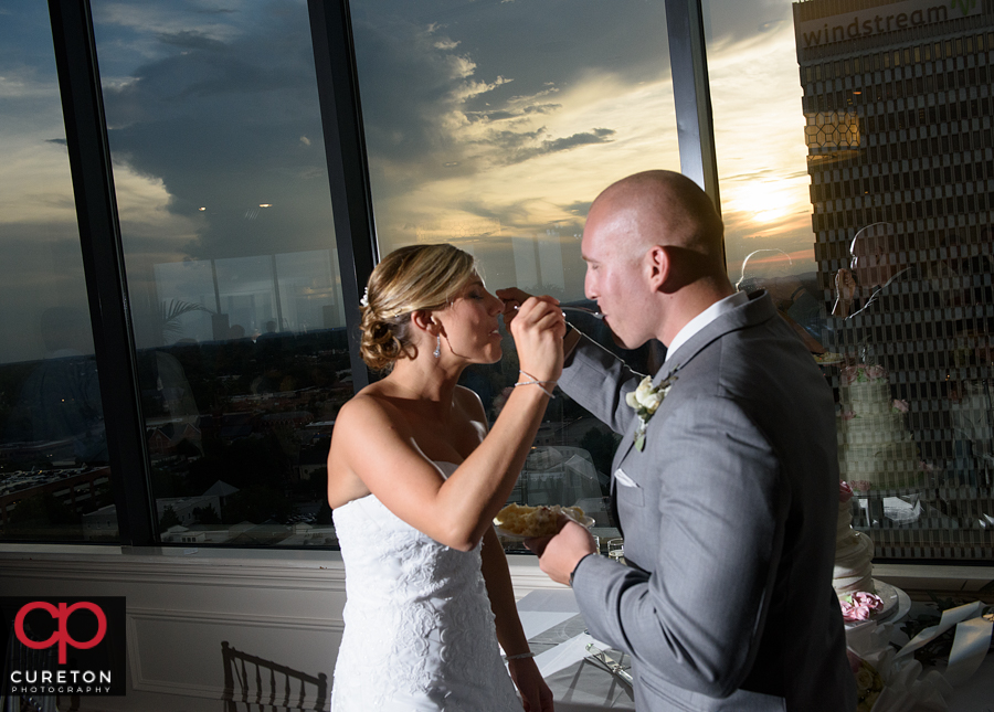 Bride and groom cutting the cake.