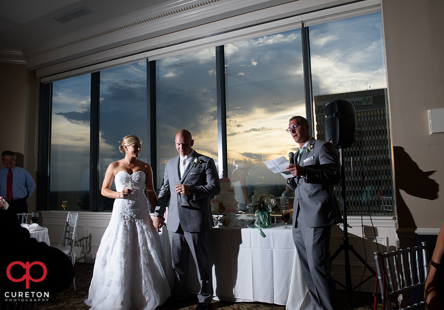 Bride and groom are toasted at the reception.