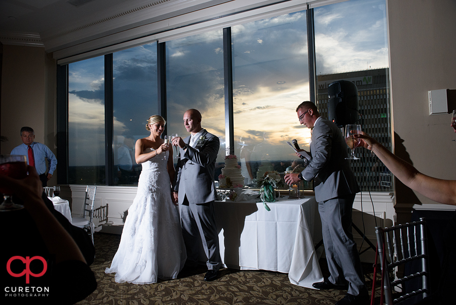 Bride and groom are toasted at the reception.