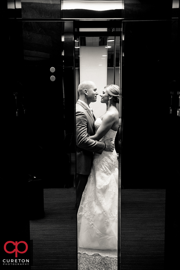 Bride and groom in the elevator at their Commerce Club wedding.