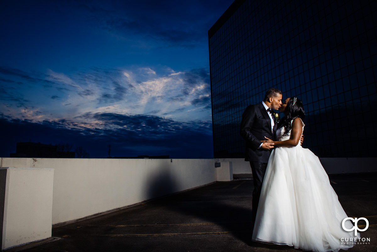 Bride and Groom on the rooftop at sunset after their Commerce Club Greenville wedding.