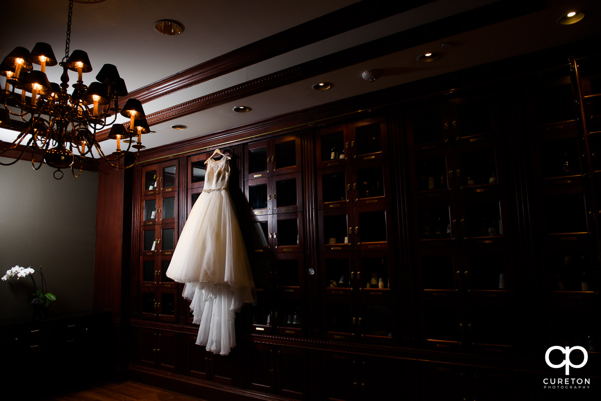 Wedding dress hanging in the wine room at The Commerce Club.