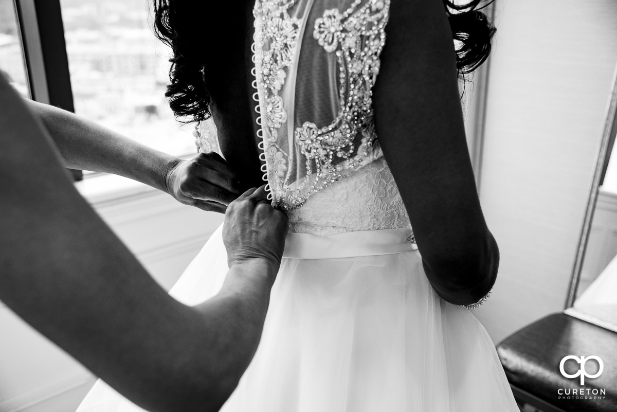 Bride getting into her dress.