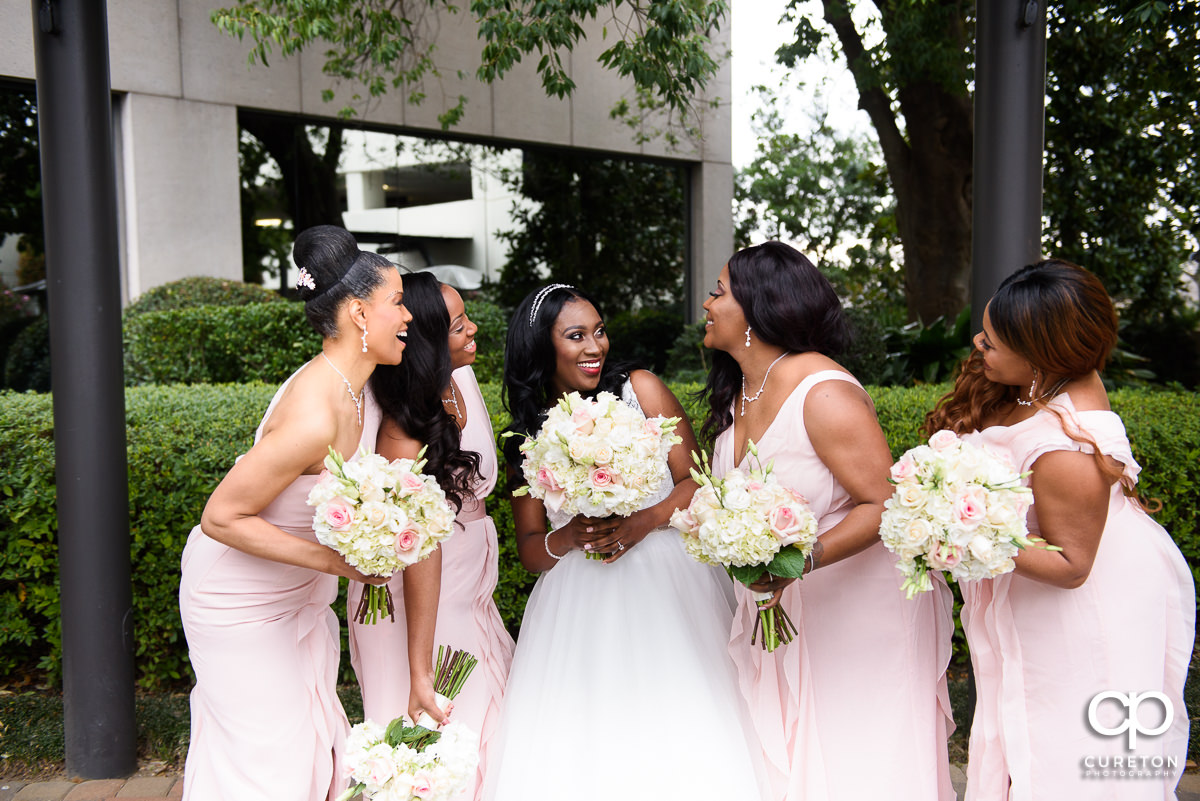 Bride laughing with her bridesmaids.