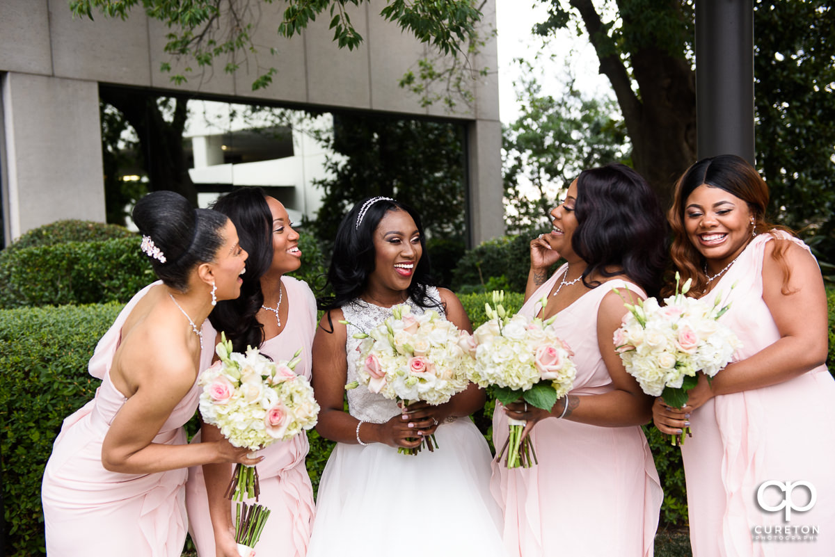 Bride and her bridesmaids having a good time before the spring wedding.