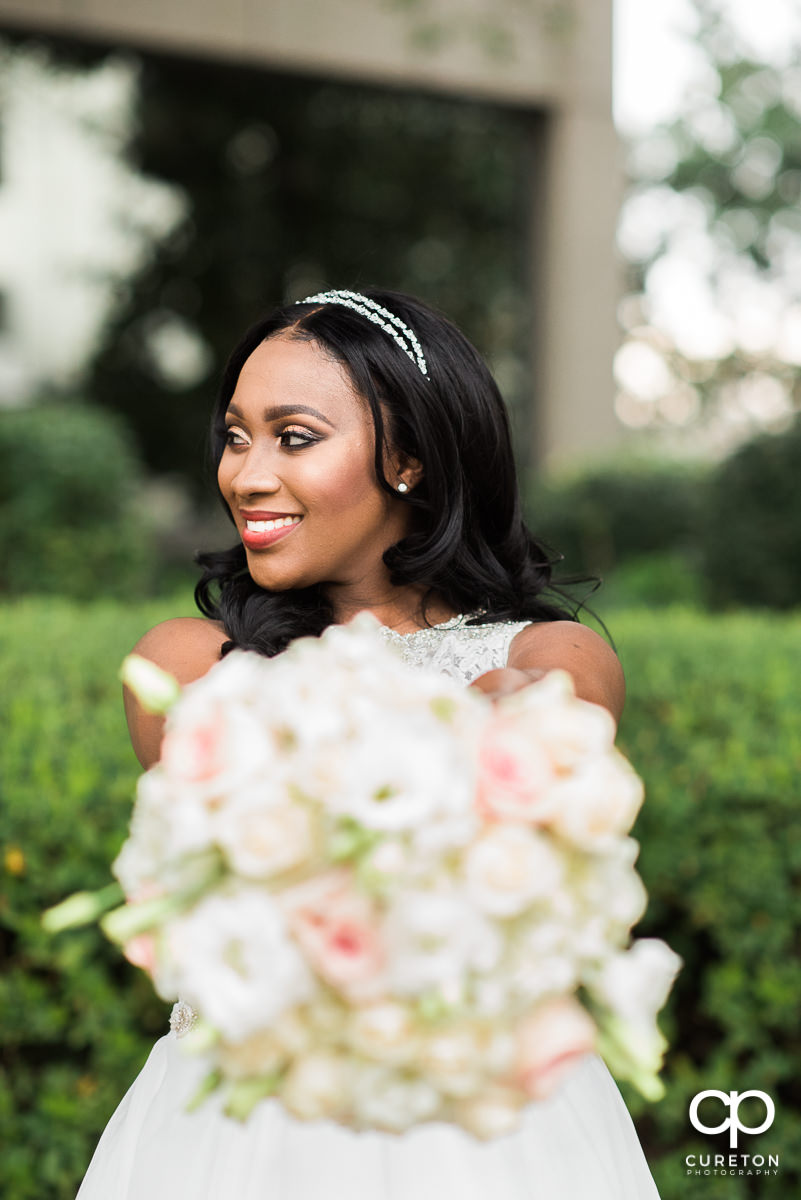 Bride showing off her bouquet.