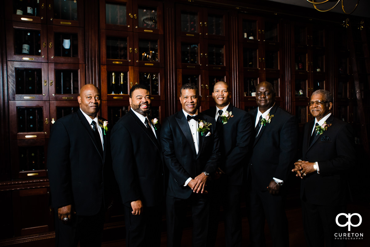 Groom and groomsmen in the wine room at the Commerce Club before the wedding ceremony.