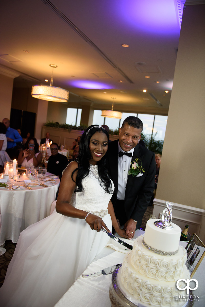 Bride and groom cutting the cake from Couture Cakes.