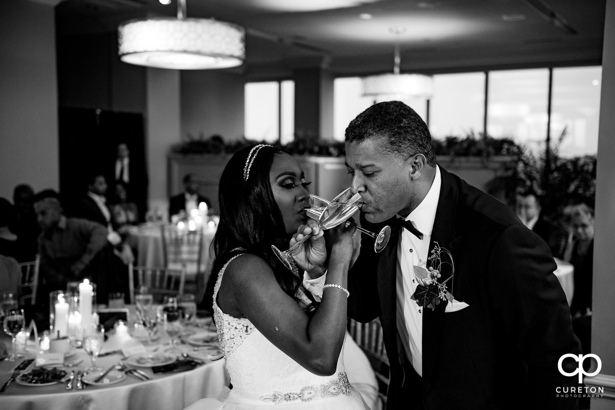 Bride and groom sharing a traditional toast.