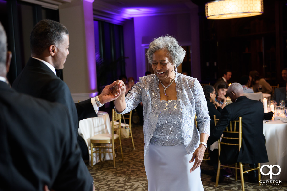 Bride and groom dancing with their parents.