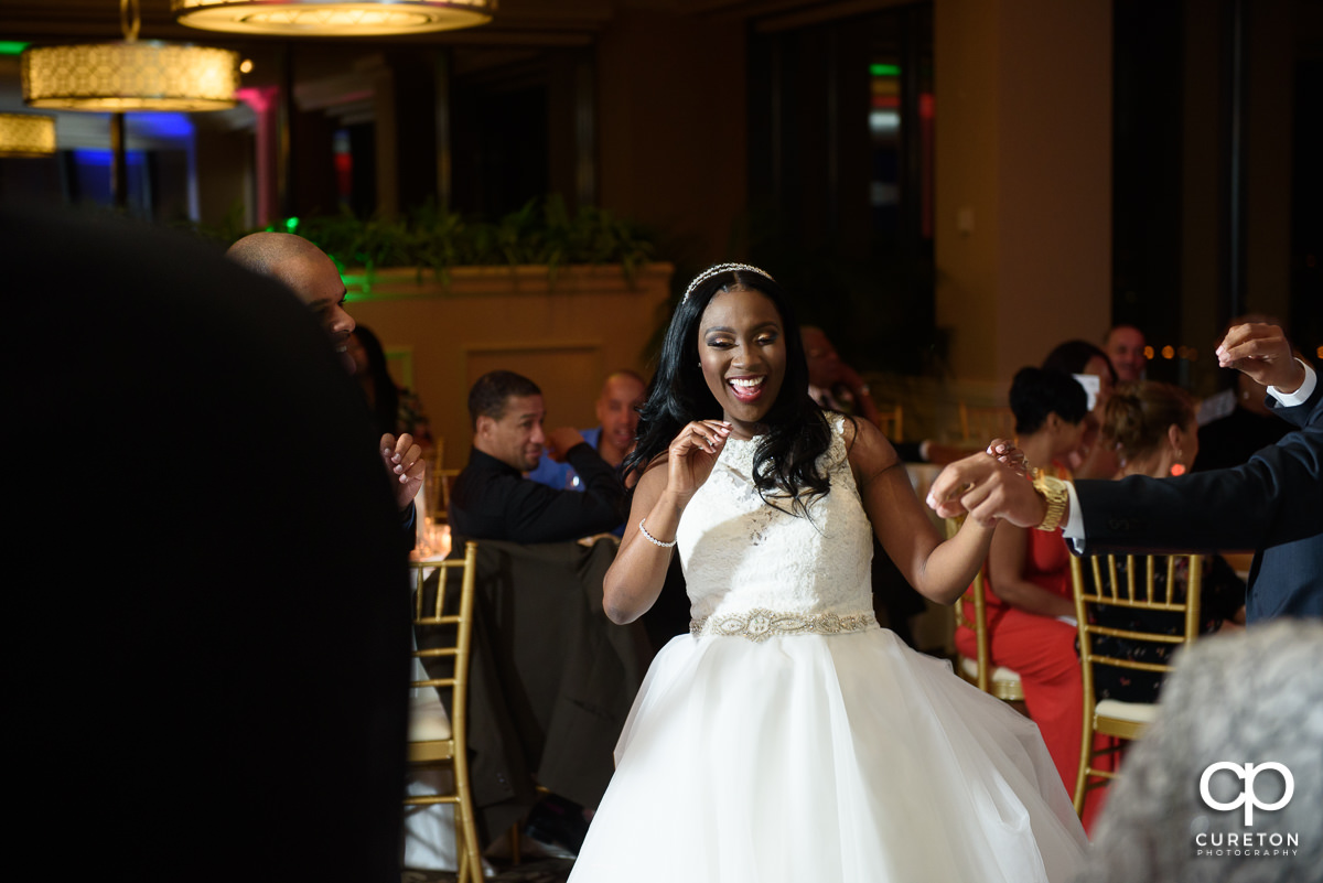 Bride smiling and laughing on the dance floor.