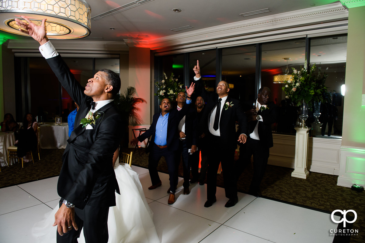 Groom tossing the garter.