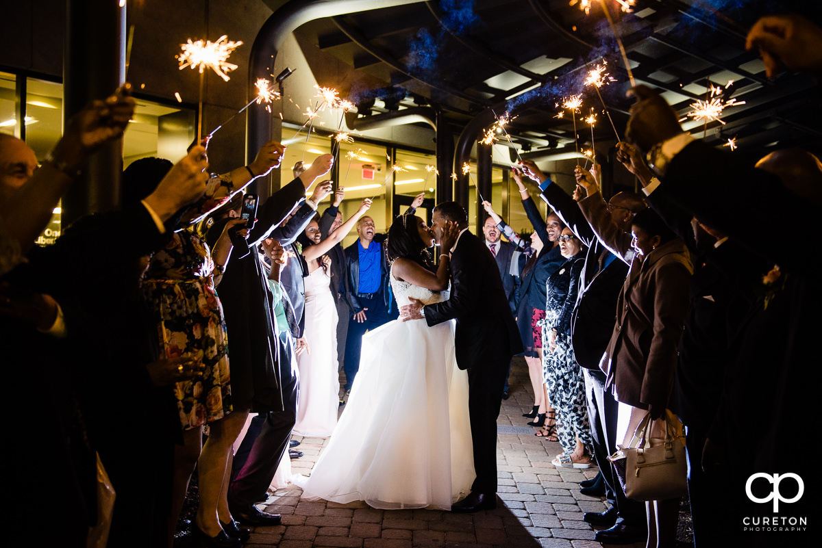 Bride and groom making a grand sparkler exit at The Commerce Club wedding reception.