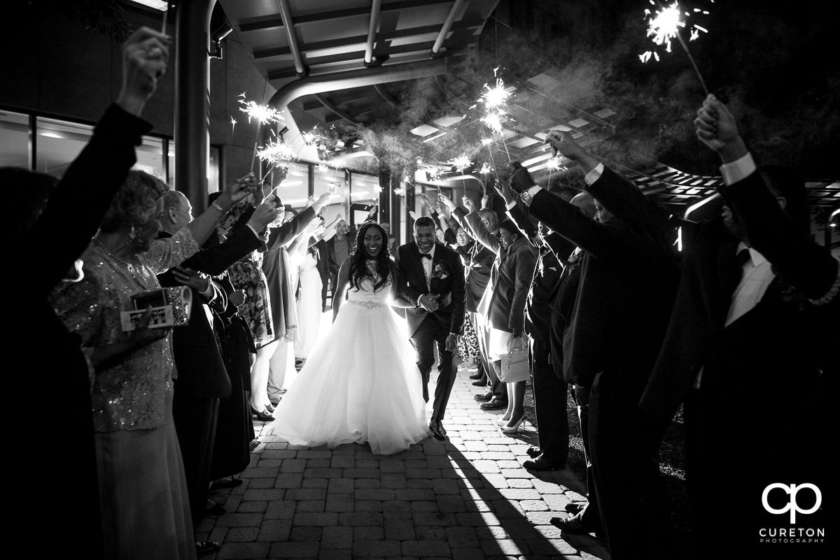 Bride and groom making a grand sparkler exit at The Commerce Club wedding reception in downtown Greenville.