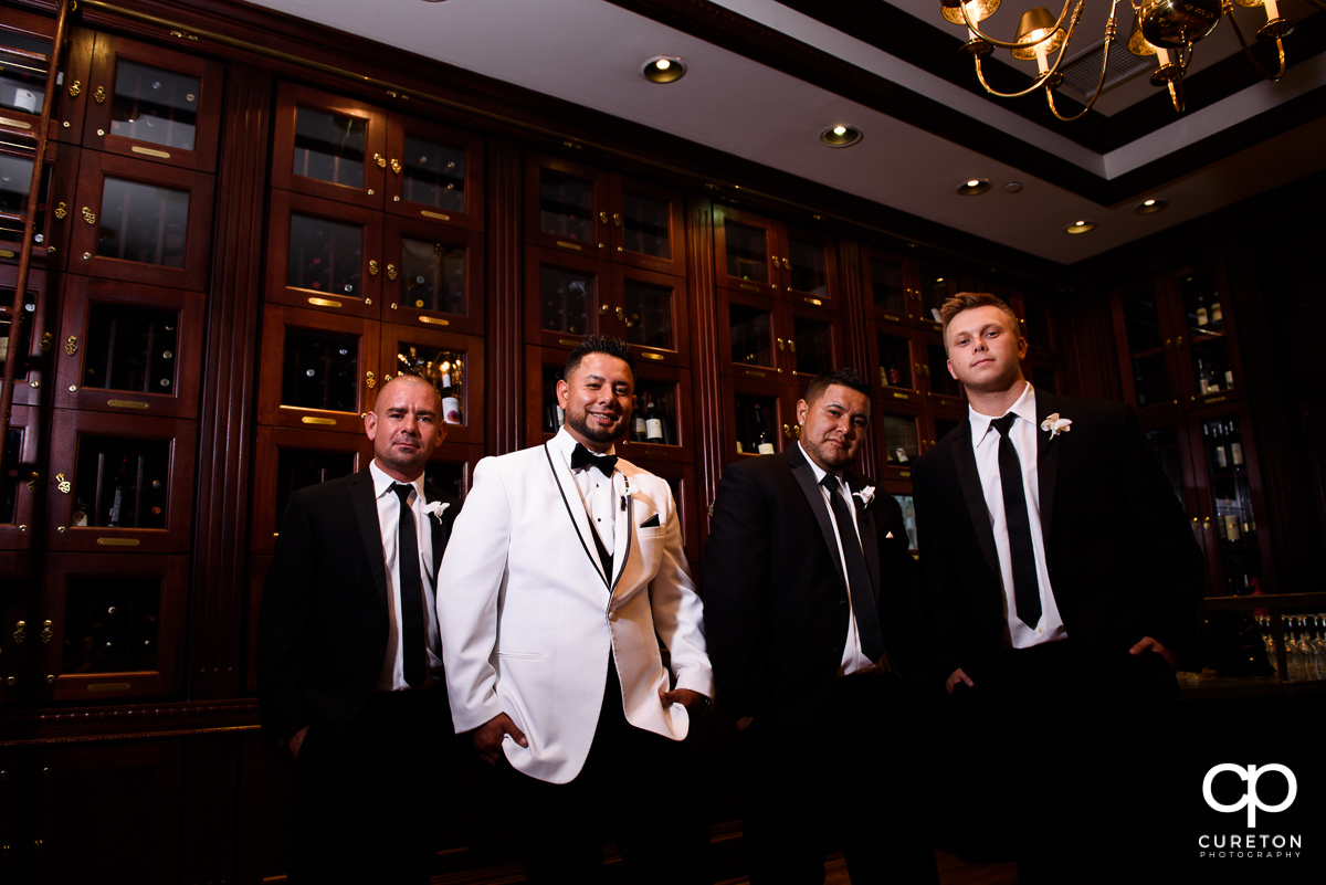 Groom and groomsmen in the wine room at the Commerce Club before the wedding.