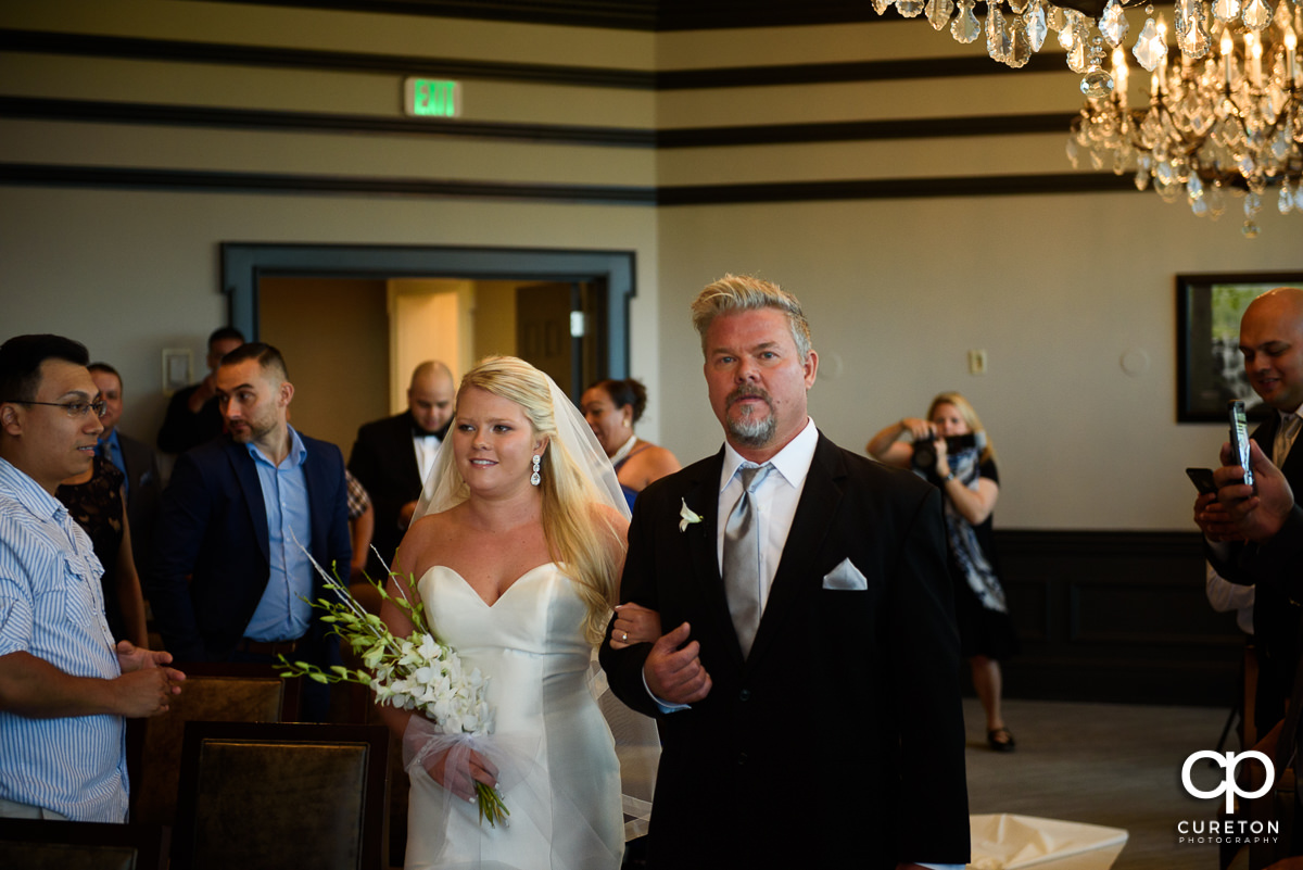 Bride and her father walking down the aisle at the Commerce Club.