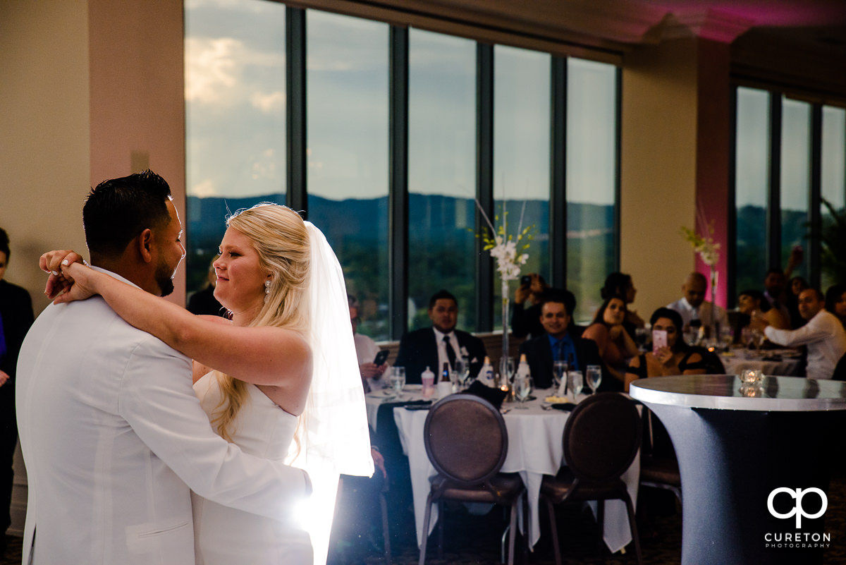 Backlit photo of bride and groom during their first dance at the Commerce Club wedding reception.