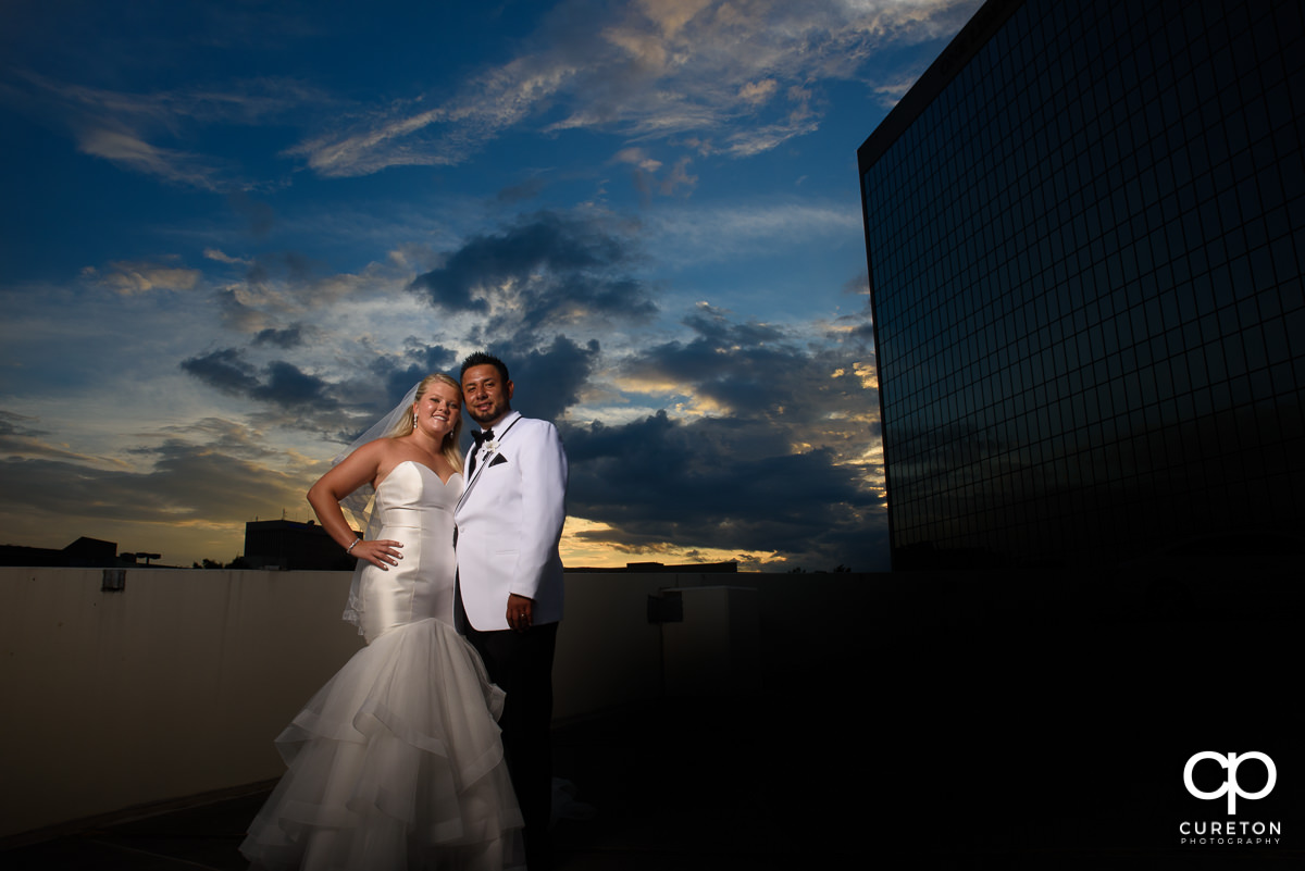 Bride and groom with epic sunset background.