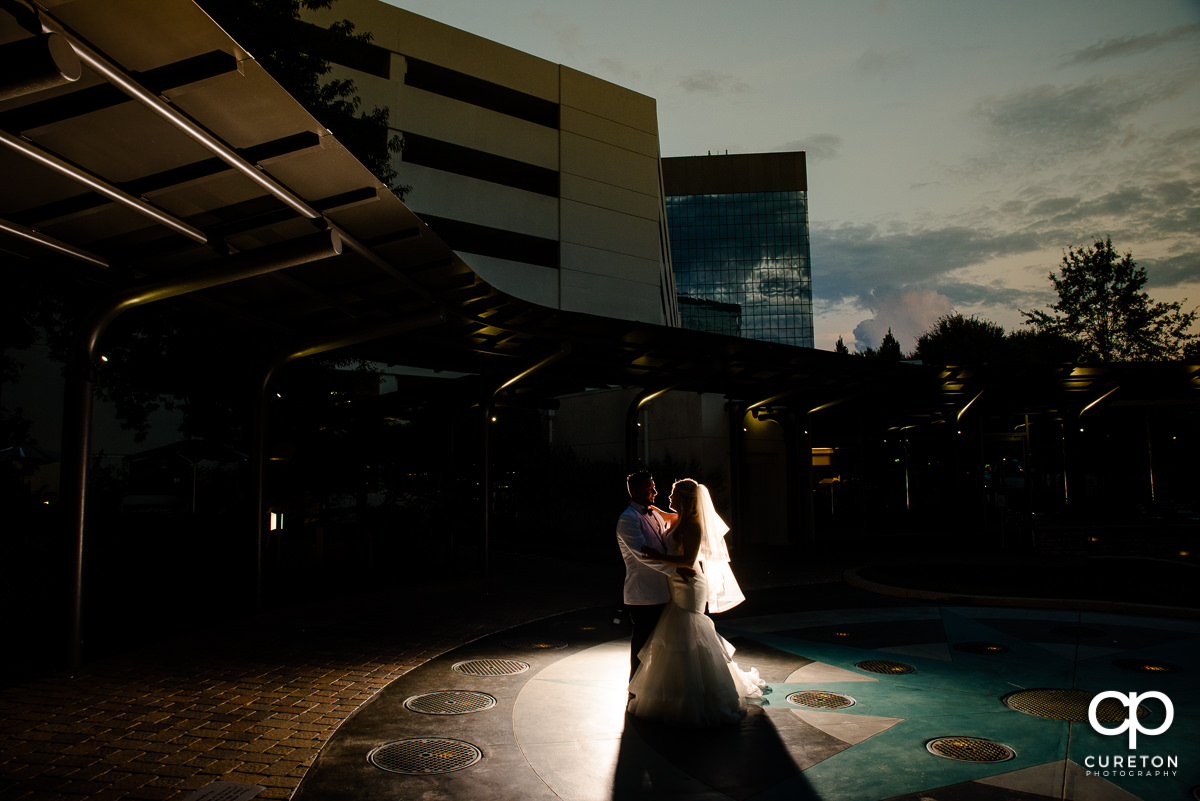 Epic backlit photo of bride and groom at the Commerce Club.