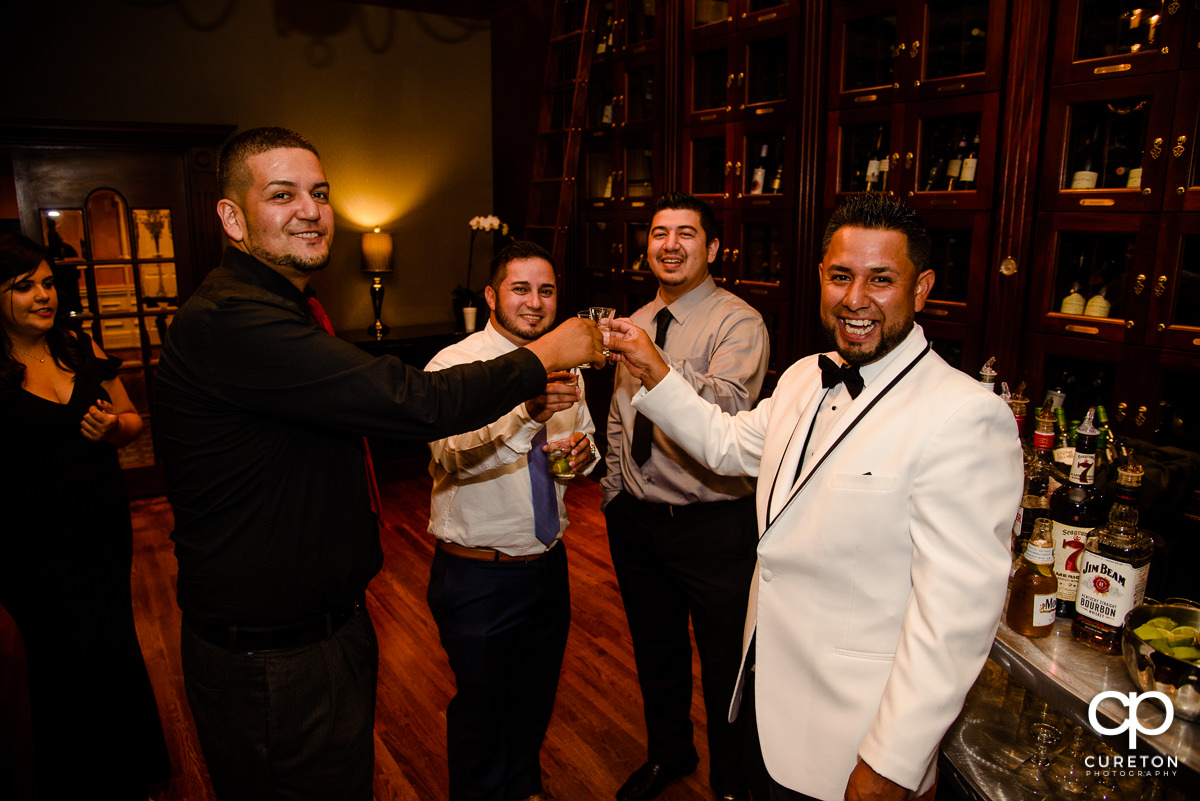 Groom and friends at the bar.