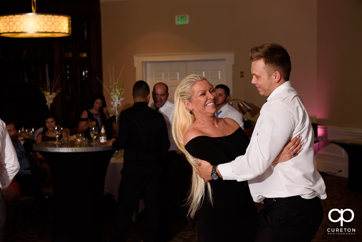 Bride's mom dancing with her son.