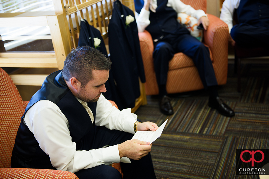 Groom reading a letter from his bride.