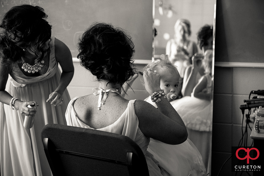 Flower girl getting her hair done.