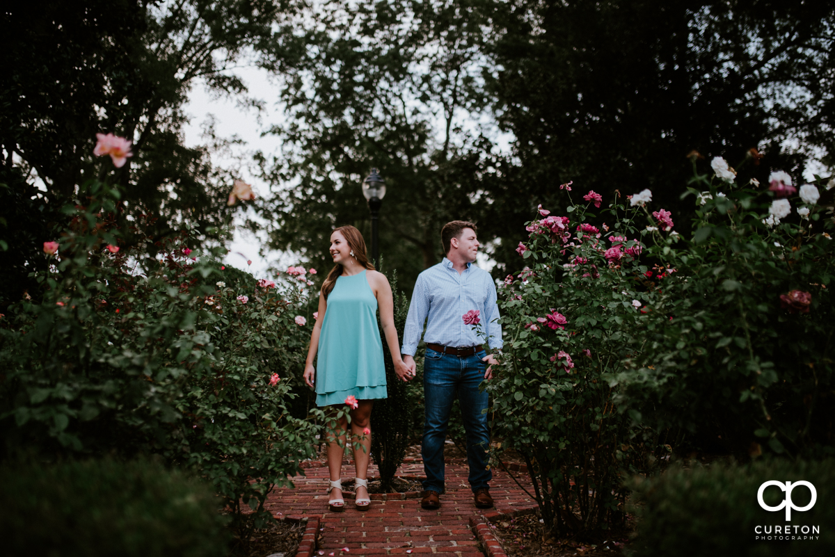 Couple hanging out in the rose garden at Furman University.