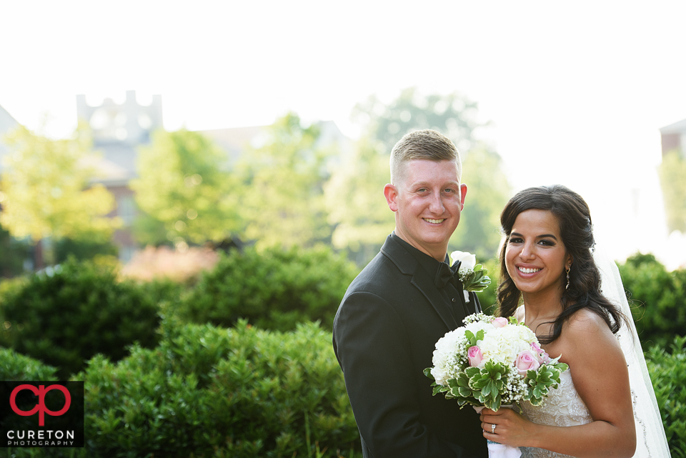 Bride and groom standing outside Daniel chapel.