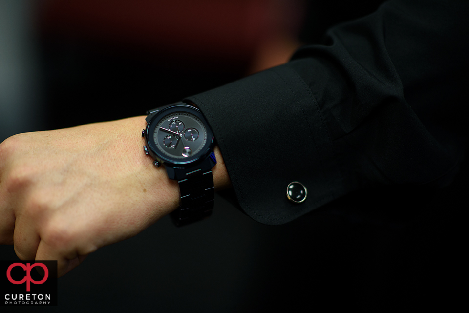 The groom showing off his watch which was a gift from his bride.