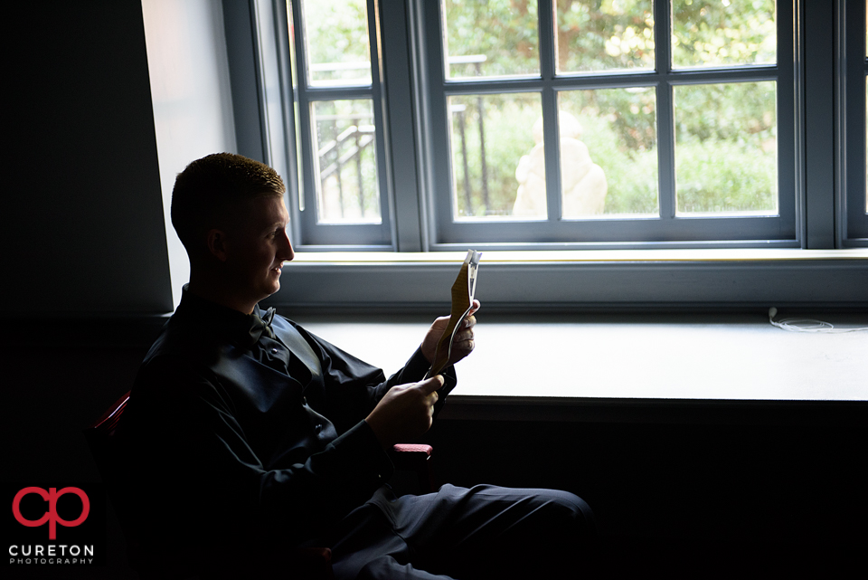 The groom reading a letter from his bride.