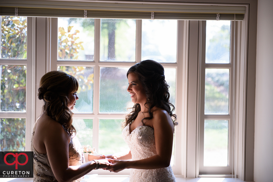 The bride and her mother sharing a moment before the Daniel chapel wedding.