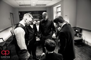 The groom and groomsmen praying before the wedding.