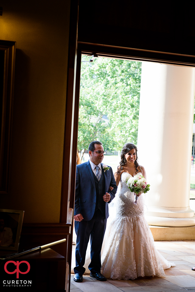 The bride and her father make a grand entrance.