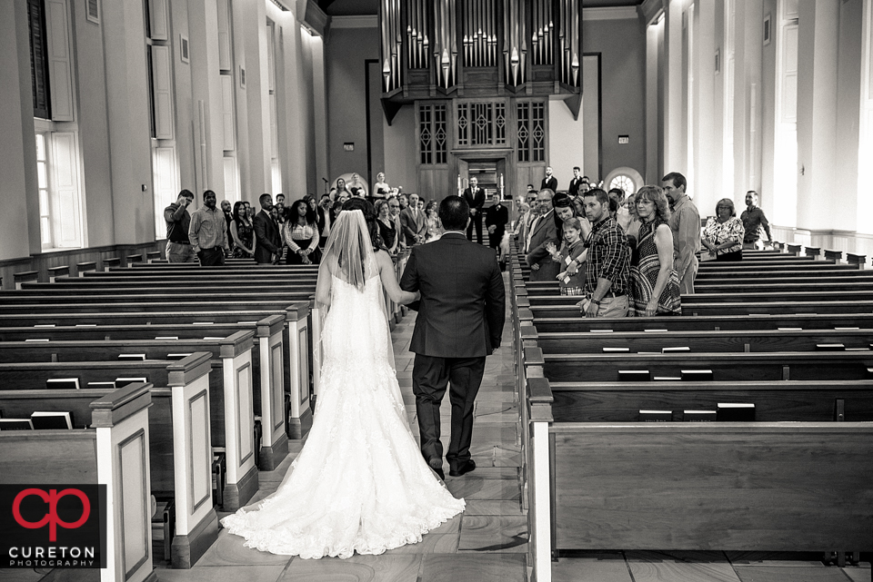 The bride and her father walking down the aisle at Daniel chapel.