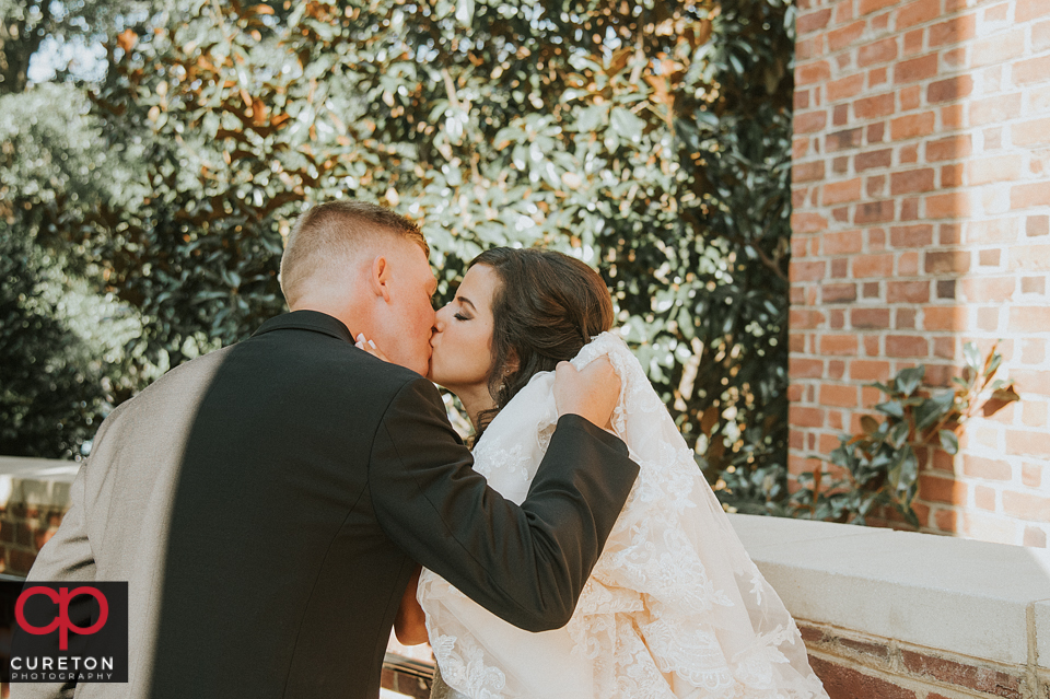 Bride and groom kissing after their wedding.