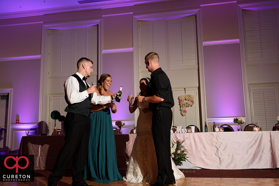 Bride and groom listening to the toasts from the wedding party.