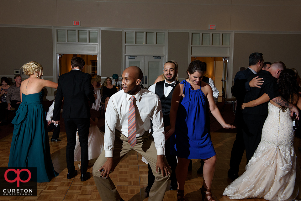 Wedding guest dancing to the sounds of Uptown Entertainment at the Younts Center wedding reception.