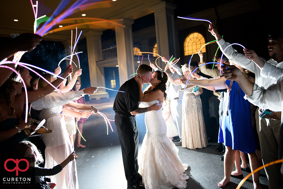 Bride and groom's glow stick leave after their wedding reception at Furman.